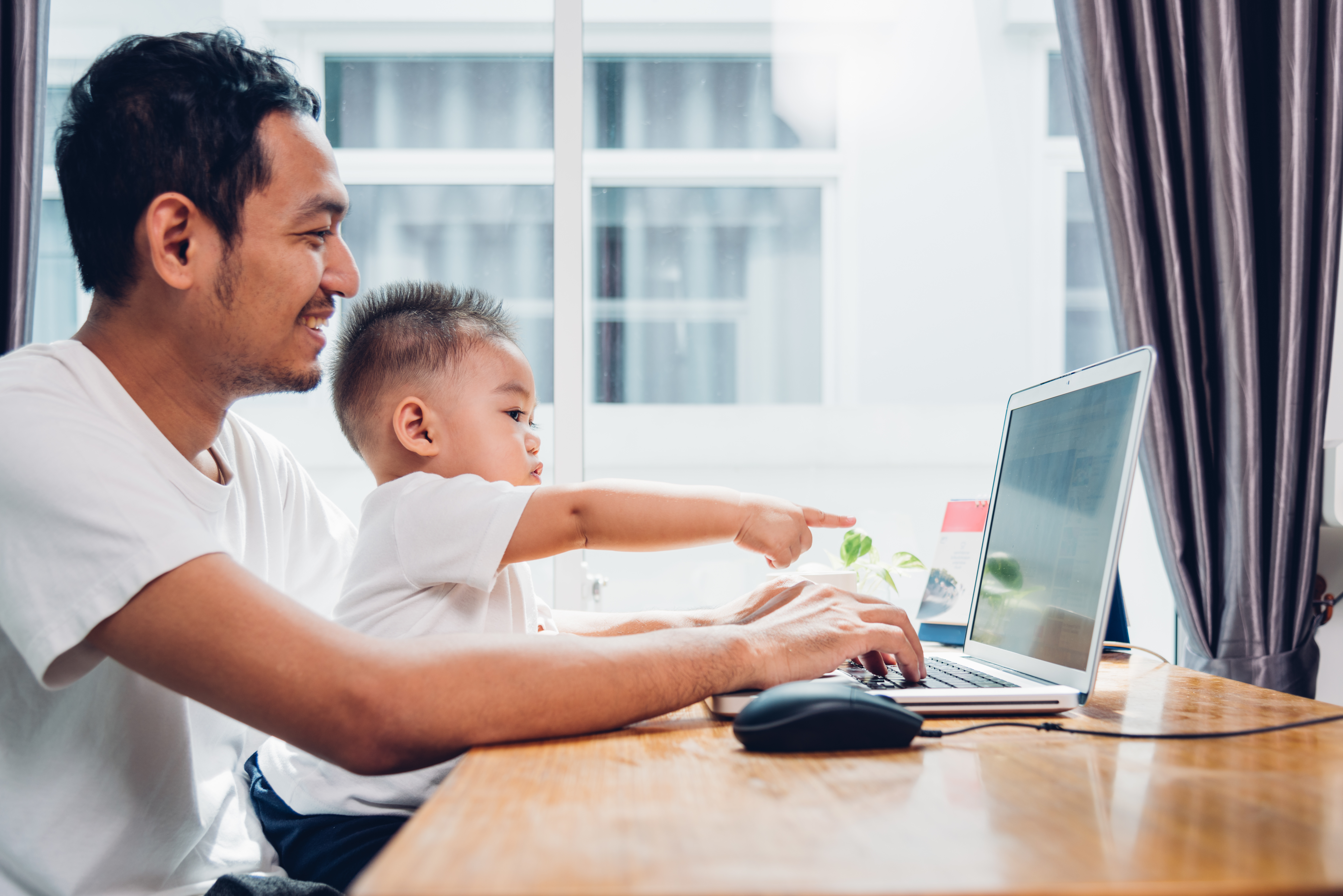 Father and son looking at a laptop